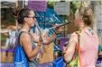 People Inspecting Incense at the Festival
