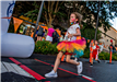 Child in Rainbow Skirt Crosses the Finish Line