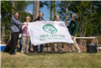 5 People Holding Tree City USA Flag