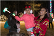 Woman Holding Child with Glowing Wand