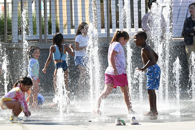 Children playing in a fountain.