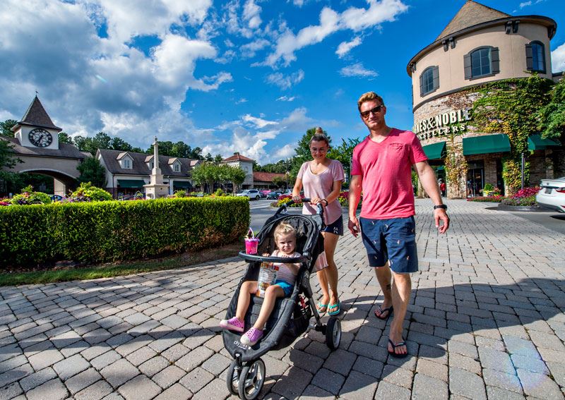People with a baby walking at the Forum.