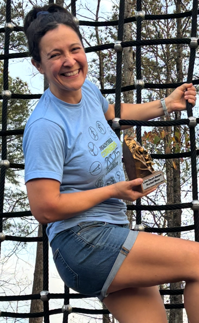 Rachel Moor holding the Lion Heart trophy