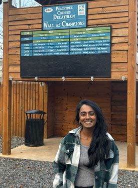 Sri Jackson in front of the wall